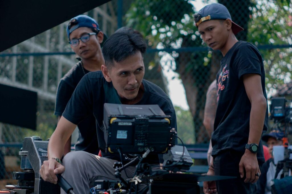 The Art of Drawing Readers In: Your attractive post title goes here Group of filmmakers reviewing footage on set outdoors, focused on camera equipment.