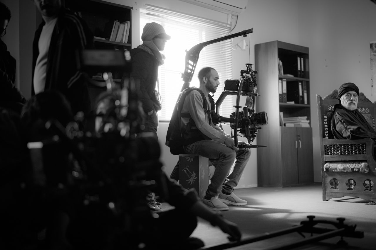 Mastering the First Impression: Your intriguing post title goes here Black and white photo of a film crew working indoors with high-end camera equipment.